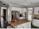 Spacious kitchen with a center island, stainless steel appliances, granite countertops, and ample cabinet space at 365 Autumn Breeze Dr, Roswell, GA 30075