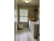 Bright laundry room with white tile floors, front load washer and dryer, and woven hamper and basket at 365 Autumn Breeze Dr, Roswell, GA 30075