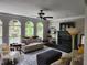 Inviting living room with arched windows, fireplace, ceiling fan, and stylish decor, providing a comfortable space at 365 Autumn Breeze Dr, Roswell, GA 30075