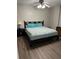 Comfortable main bedroom with a queen-sized bed, stylish nightstands, and wood-look floors at 365 Autumn Breeze Dr, Roswell, GA 30075