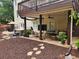 Relaxing covered patio with a hot tub, lounge seating, and outdoor entertainment setup at 365 Autumn Breeze Dr, Roswell, GA 30075