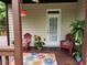Inviting covered patio with comfortable seating, outdoor plants, and a decorative floral rug at 365 Autumn Breeze Dr, Roswell, GA 30075