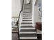 Elegant staircase with dark hardwood flooring, white risers, and natural light at 365 Autumn Breeze Dr, Roswell, GA 30075