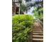 Wooden stairs leading to an upper-level porch, surrounded by lush greenery at 365 Autumn Breeze Dr, Roswell, GA 30075