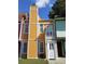 Charming townhome featuring a yellow exterior, white trim, and a small balcony, offering a cozy curb appeal at 3820 London Dr Dr, Decatur, GA 30032