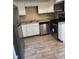 Well-lit kitchen featuring stainless steel appliances, light countertops, and wood-look tile flooring at 3820 London Dr Dr, Decatur, GA 30032