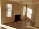 Bright living room with fireplace and wood-look floors, offering a cozy space for Gathering gatherings and relaxation at 3820 London Dr Dr, Decatur, GA 30032