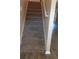 Carpeted staircase with white railing, offering a safe transition between floors, adding comfort and style at 3820 London Dr Dr, Decatur, GA 30032