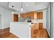 Bright kitchen with wood cabinets, stainless steel appliances, island, hardwood floors, and floor-to-ceiling windows at 855 Peachtree Ne St # 2713, Atlanta, GA 30308