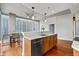 Contemporary kitchen with a stainless steel dishwasher, breakfast bar, and floor-to-ceiling windows with city views at 855 Peachtree Ne St # 2713, Atlanta, GA 30308