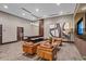 Stylish lounge featuring comfortable leather seating, modern artwork, and a bar height table with bar stools at 855 Peachtree Ne St # 2713, Atlanta, GA 30308