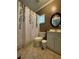Cozy bathroom with white shower curtain, toilet, white cabinets, and vanity at 1624 Beecher Sw St, Atlanta, GA 30310