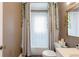 Bathroom features a shower with curtain, toilet, and mirror above a vanity at 1624 Beecher Sw St, Atlanta, GA 30310