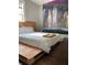 Unique bedroom design with a waterfall mural feature, hardwood floors, and minimalist decor at 1624 Beecher Sw St, Atlanta, GA 30310