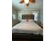 This bedroom has a large bed with decorative pillows, side tables, and a dresser at 1624 Beecher Sw St, Atlanta, GA 30310