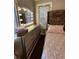 This bedroom features a vanity with lighted mirror and a view to the outside at 1624 Beecher Sw St, Atlanta, GA 30310