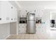 Functional kitchen featuring white cabinets, stainless steel refrigerator, and tiled floors at 1624 Beecher Sw St, Atlanta, GA 30310