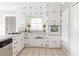 Well-lit kitchen boasting ample white cabinetry and tiled floors, perfect for culinary enthusiasts at 1624 Beecher Sw St, Atlanta, GA 30310