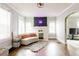 Bright living room with hardwood floors, large windows, and a decorative fireplace with neon sign at 1624 Beecher Sw St, Atlanta, GA 30310