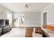 Spacious living area with hardwood floors, a comfortable sofa, and access to the dining room at 1624 Beecher Sw St, Atlanta, GA 30310