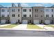 View of new townhome featuring an attached garage and modern brick and siding exterior at 4964 Villager Ln, Stone Mountain, GA 30083