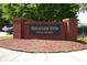 Image of the 'Mountain View Villages' community sign set amongst greenery and a nearby sidewalk at 4964 Villager Ln, Stone Mountain, GA 30083