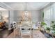 Elegant dining area with a white table, upholstered chairs, and stylish pendant lighting at 5 Newport Nw Pl, Atlanta, GA 30318
