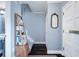 Bright entryway with hardwood floors, coat closet, and decorative mirror at 5 Newport Nw Pl, Atlanta, GA 30318