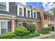 Charming brick townhome with dormer windows, black shutters and a professionally landscaped front at 5 Newport Nw Pl, Atlanta, GA 30318