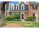 Charming brick townhome with well-maintained landscaping, black shutters, and a welcoming entrance at 5 Newport Nw Pl, Atlanta, GA 30318
