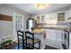 Cozy kitchen with white cabinets, stainless steel appliances, and a charming breakfast bar at 5 Newport Nw Pl, Atlanta, GA 30318