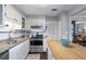 Modern kitchen with stainless steel appliances, white cabinets, and access to living space at 5 Newport Nw Pl, Atlanta, GA 30318