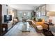 Bright and airy living room with a leather couch, patterned rug, and decorative accents at 5 Newport Nw Pl, Atlanta, GA 30318
