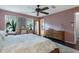 Bright main bedroom with a ceiling fan, hardwood floors, and windows for natural light at 5 Newport Nw Pl, Atlanta, GA 30318