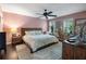 Spacious main bedroom features a ceiling fan, windows for natural light, and a walk in closet at 5 Newport Nw Pl, Atlanta, GA 30318