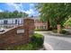 Welcome to Newport Place: view of the neighborhood with brick signage and well-maintained landscaping at 5 Newport Nw Pl, Atlanta, GA 30318