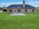 View of the home's backyard showing a concrete patio, green lawn, and siding at 5291 Tuscany Dr, Douglasville, GA 30135