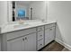 Well-lit bathroom featuring a double vanity with white countertop and spacious under-sink storage at 5291 Tuscany Dr, Douglasville, GA 30135