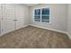 Bedroom features large closet doors, neutral colors, and a bright window at 5291 Tuscany Dr, Douglasville, GA 30135