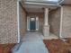 Inviting front entrance featuring a teal door, brick accents, and well-maintained landscaping at 5291 Tuscany Dr, Douglasville, GA 30135