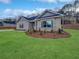 Beautiful one-story brick home featuring professionally landscaped flower beds and a lush, green lawn at 5291 Tuscany Dr, Douglasville, GA 30135