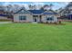 Charming brick home with a well-manicured lawn, complemented by dark blue shutters and a matching door at 5291 Tuscany Dr, Douglasville, GA 30135