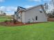 Side view of a gray home with a well-manicured lawn and mulch landscaping at 5291 Tuscany Dr, Douglasville, GA 30135