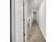 Upstairs hallway featuring neutral colored carpet, white trim, and doors at 5291 Tuscany Dr, Douglasville, GA 30135