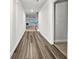 Hallway with hardwood flooring leading to the living room with fireplace at 5291 Tuscany Dr, Douglasville, GA 30135