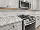 Kitchen features granite countertops, subway tile backsplash, and stainless steel appliances at 5291 Tuscany Dr, Douglasville, GA 30135