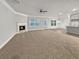 Expansive living room features a fireplace, plush carpeting, recessed lighting, and bright windows at 5291 Tuscany Dr, Douglasville, GA 30135