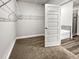 Walk-in closet with built-in shelving and easy access to the attached primary bathroom at 5291 Tuscany Dr, Douglasville, GA 30135