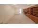 Finished basement with built-in bookshelves and neutral carpet, a cozy space for relaxation at 6835 Castleton Dr, Sandy Springs, GA 30328