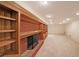 Basement with brick fireplace and built-in wood shelving, perfect for storage or decor at 6835 Castleton Dr, Sandy Springs, GA 30328